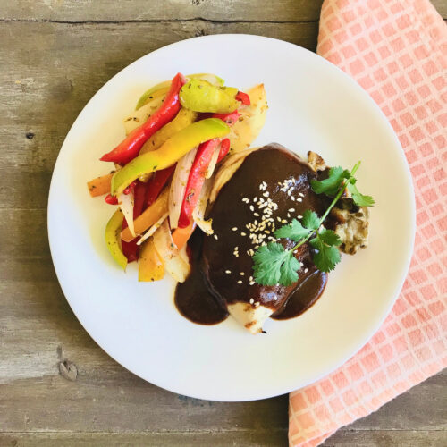 Mole chicken with sautéed peppers and onion