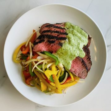 Grilled flank steak with sauteed pepper and onion
